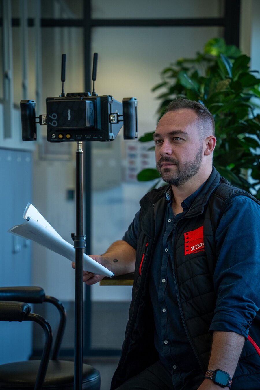 Reece King of King Productions on set, holding a script beside a camera rig